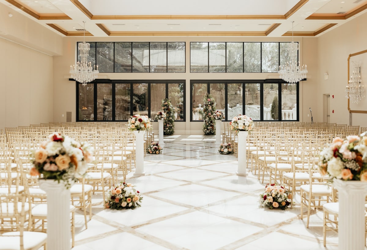 Indoor chapel ceremony with white florals at Lucien's Manor