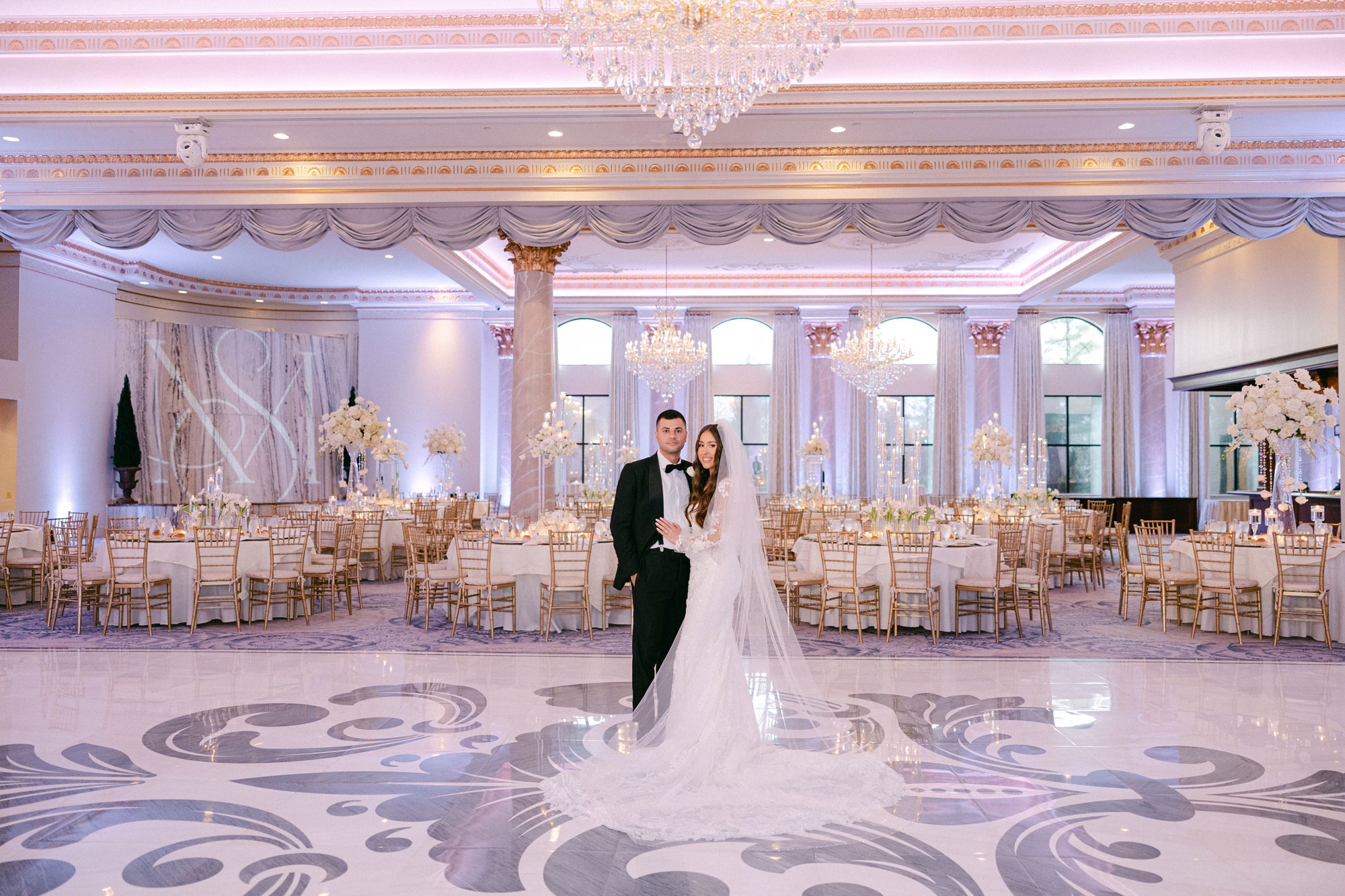 A bride and groom in the grand ballroom at Lucien's Manor