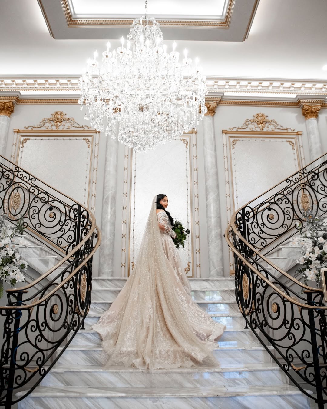 Bride on the staircase, veil flowing